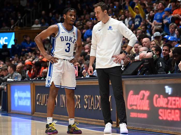 Duke coach Jon Scheyer talks to guard Jeremy Roach during a timeout against Virginia Tech.